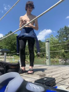 Standing on a dock with long hair